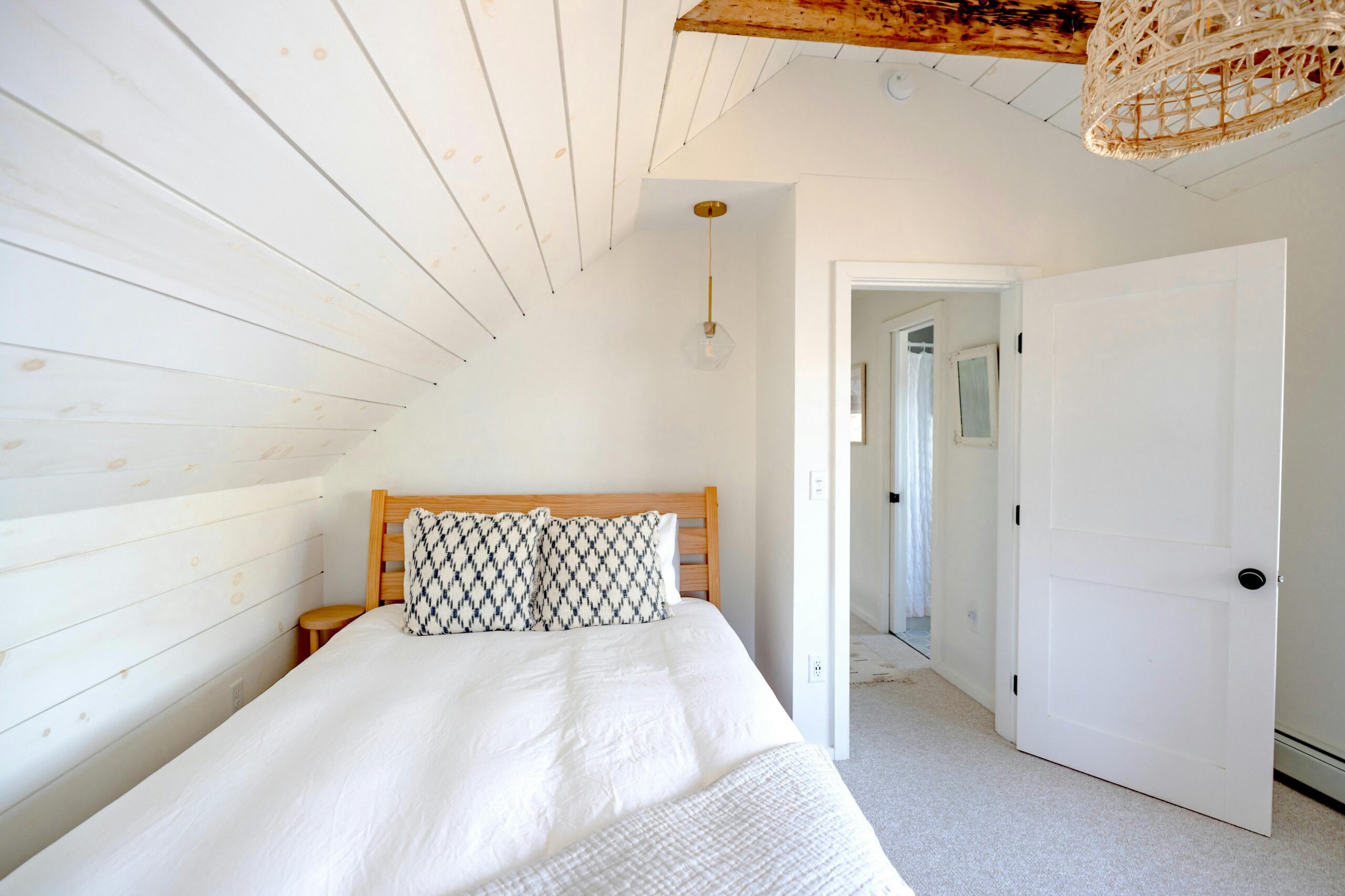 Bright and minimalist bedroom interior with rustic features and natural lighting.